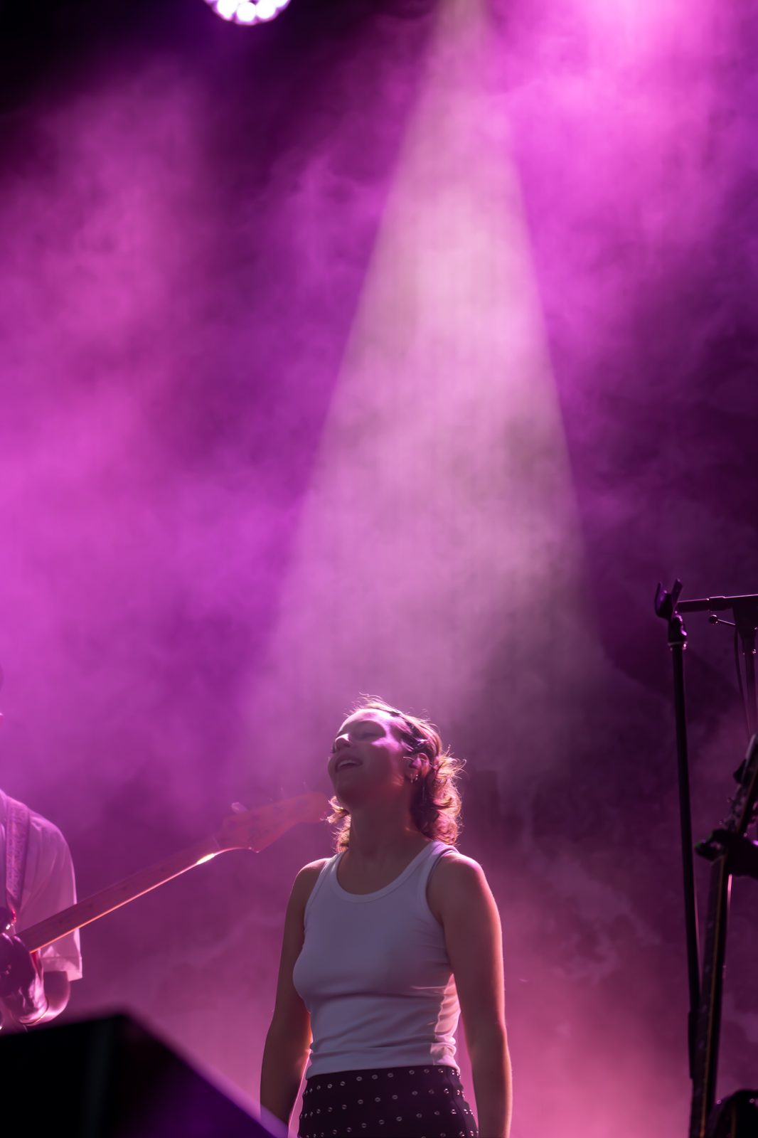 Silhouette d'une chanteuse sous un puissant faisceau violet